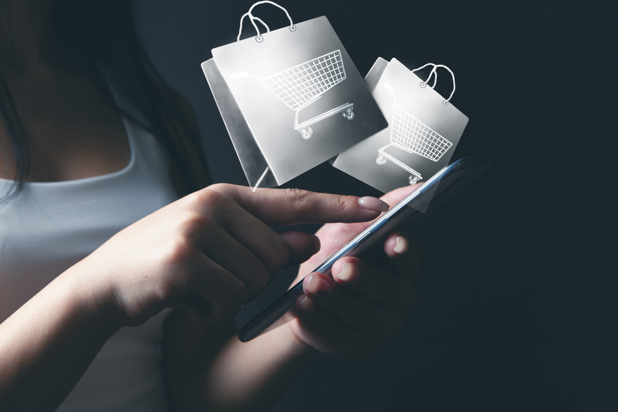 woman makes online shopping by phone. shopping basket